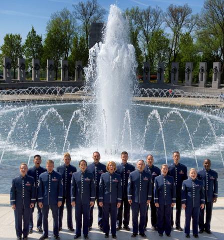 a group of people standing in front of a fountain